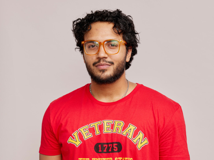 A young man wearing a red Marines shirt. 