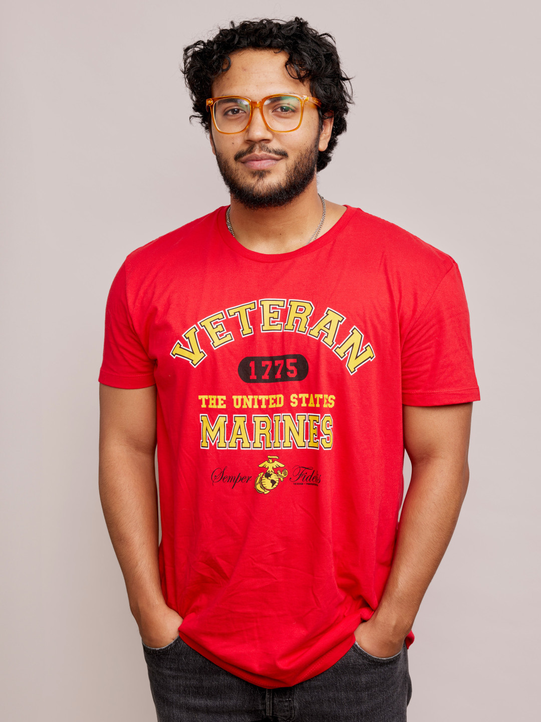 A young man wearing a red Marines shirt. 